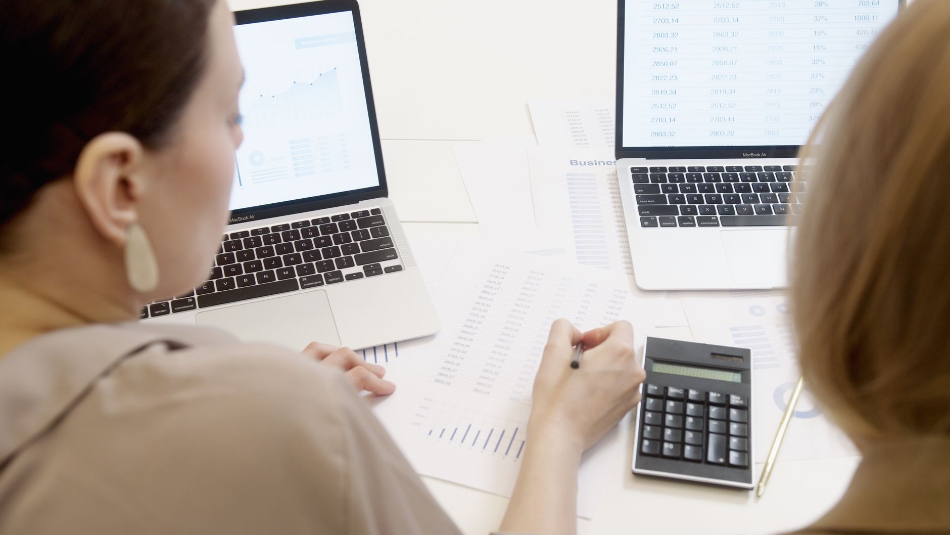 An export manager entering checklist items into a spreadsheet while auditing a product page