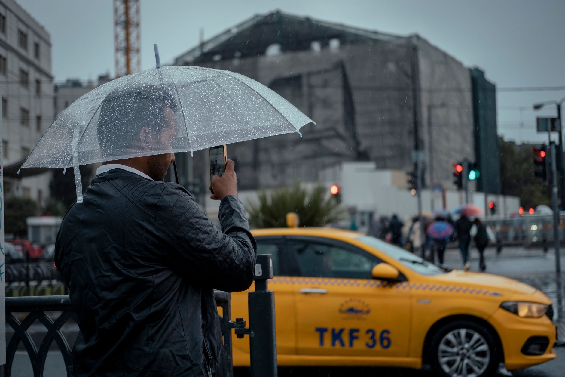 An international sales manager looking flustered while checking a smartphone map on a rainy street of an unfamiliar city
