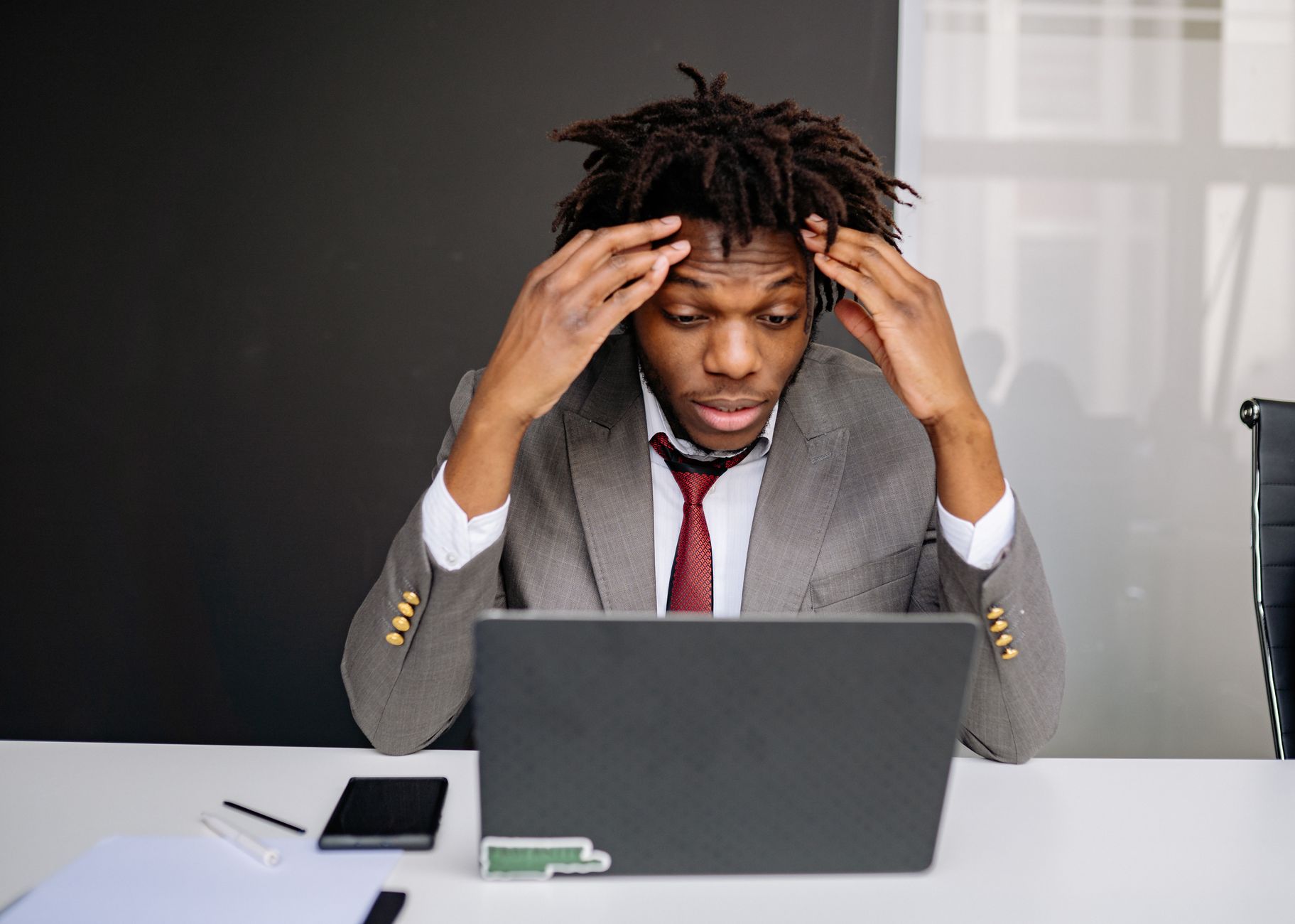 A frustrated global business executive looking at a laptop screen showing a loading spinner with a 'Connection Timeout' warning, representing conversion loss.